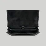 Open interior of black leather briefcase showing a padded compartment for a 15.6-inch laptop.