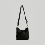 Back view of the black pebbled leather crossbody bag featuring an ergonomic U-shaped top and gold turn-lock closure