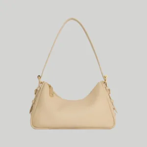 Front view of minimalist beige leather shoulder bag with adjustable strap and gold hardware