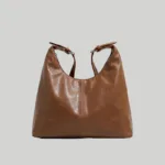 Casual brown slouchy purse for everyday wear showing adjustable buckle strap