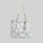 Light blue floral embossed leather tote bag featuring a pearl chain strap, Chinoiserie chic aesthetic