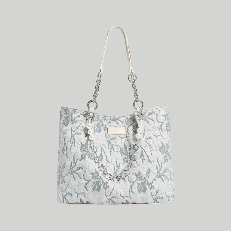 Light blue floral embossed leather tote bag featuring a pearl chain strap, Chinoiserie chic aesthetic