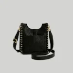 Back view of the structured black leather crossbody bag highlighting the practical external slip pocket and gold strap clasps