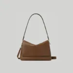 Front view of minimalist brown underarm hobo bag featuring a clean, hardware-free front profile
