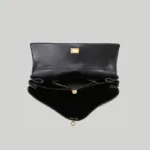 Open interior view of multi-compartment black work bag showing secure zippered divider.