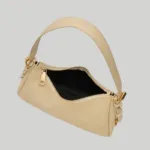Top open view of beige shoulder purse showing secure zipper closure and dark interior lining