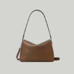 Brown minimalist slouchy shoulder bag with a V-shaped draped silhouette, quiet luxury aesthetic
