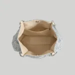 Open interior view of elegant floral tote bag showing cream lining, magnetic closure, and secure zip pockets