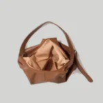 Open roomy interior of brown slouchy hobo bag showing premium lining and secure top zipper
