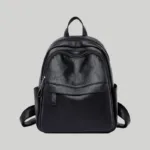 Front view of black textured vegan leather women's commuter backpack with curved zipper compartment