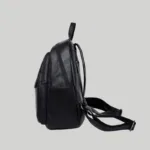 Side profile of black women's casual backpack highlighting side slip pocket and strap hardware