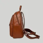 Side view of brown casual daypack demonstrating depth and base structure