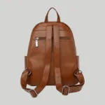 Back view of brown textured leather commuter backpack with silver-tone strap adjusters