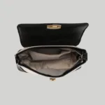 Open view of structured shoulder bag showing herringbone fabric lining and internal zipper pocket