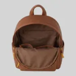 Open interior view of structured genuine leather backpack demonstrating durable fabric lining, back-wall zip pocket, and slip compartments.