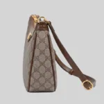 Side profile of premium underarm bag demonstrating strap hardware and structural shape retention.