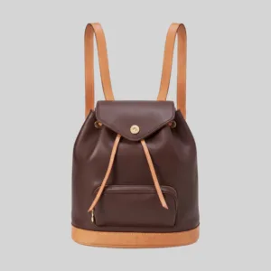 Front view of quiet luxury dark brown and tan leather rucksack with magnetic snap flap closure.