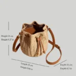 Dimensions of woven bucket bag showing length 25cm height 21cm depth 11cm