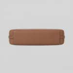 Bottom view displaying the reinforced flat base and stitching details of structured leather handbag