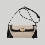 Structured two-tone canvas and leather trim shoulder bag with gold hardware front view