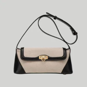 Structured two-tone canvas and leather trim shoulder bag with gold hardware front view