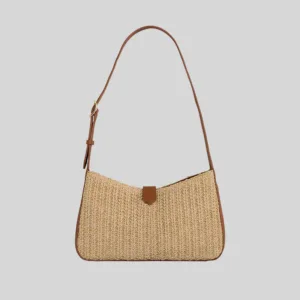 Front view of woven raffia underarm bag featuring brown leather trim and curved silhouette