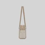Side profile of the structured beige East-West shoulder bag highlighting dual top zippers and gold-tone hardware.