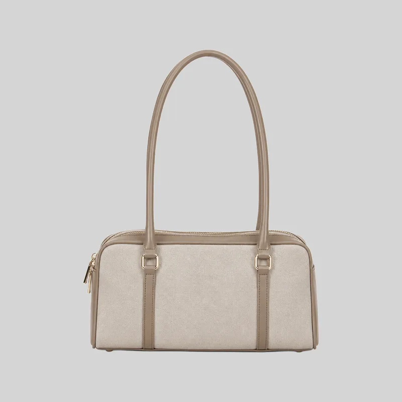 Front view of a beige structured double-zip handbag with long shoulder straps