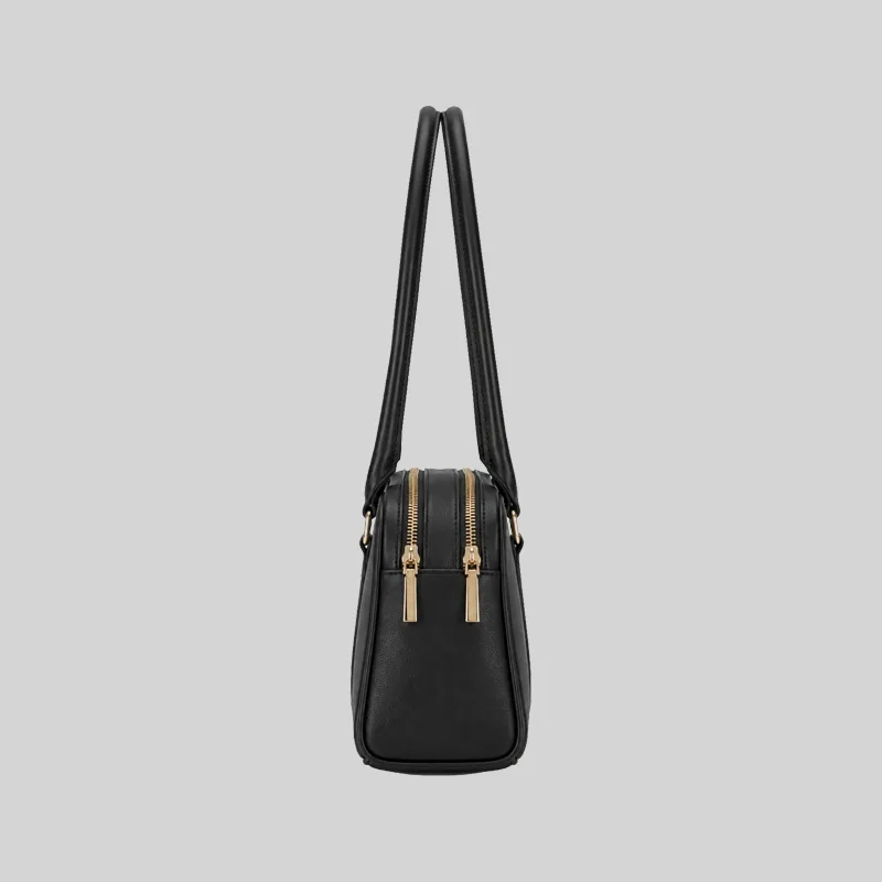 Side profile of the structured black East-West shoulder bag highlighting dual top zippers and gold-tone hardware.