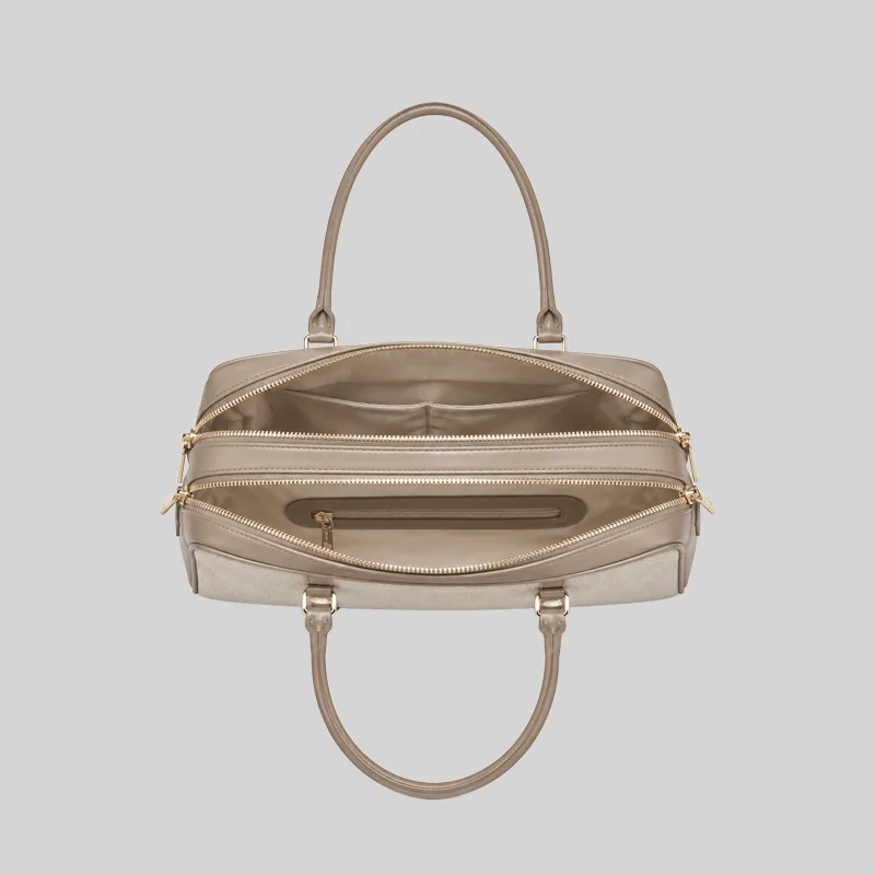 Top open view of the beige shoulder bag showing dual compartments, interior lining, and zip pockets