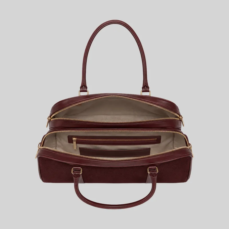 Top open view of the burgundy shoulder bag showing dual compartments, interior lining, and zip pockets