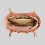 Top open view of the pink crossbody purse showing secure zipper closure and inner organizational pockets.
