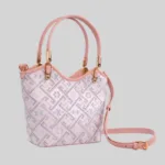 Full view of the pink tapestry handbag displaying the detachable crossbody strap and structural shape.
