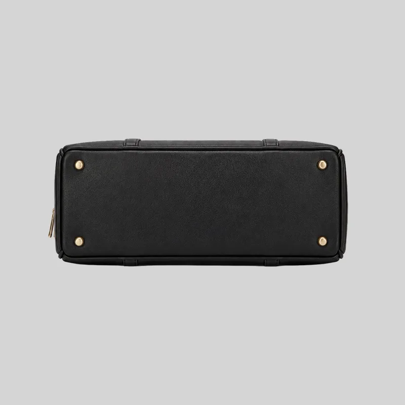 Top open view of the shoulder bag showing dual compartments, interior lining, and zip pockets, black