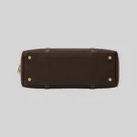 Top open view of the shoulder bag showing dual compartments, interior lining, and zip pockets, dark brown