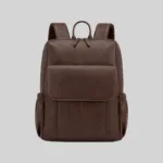 Front view of the dark brown pebbled vegan leather commuter backpack featuring a minimalist flap pocket