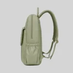 Side profile of the sage green vegan work backpack showing the water bottle pocket and ergonomic straps